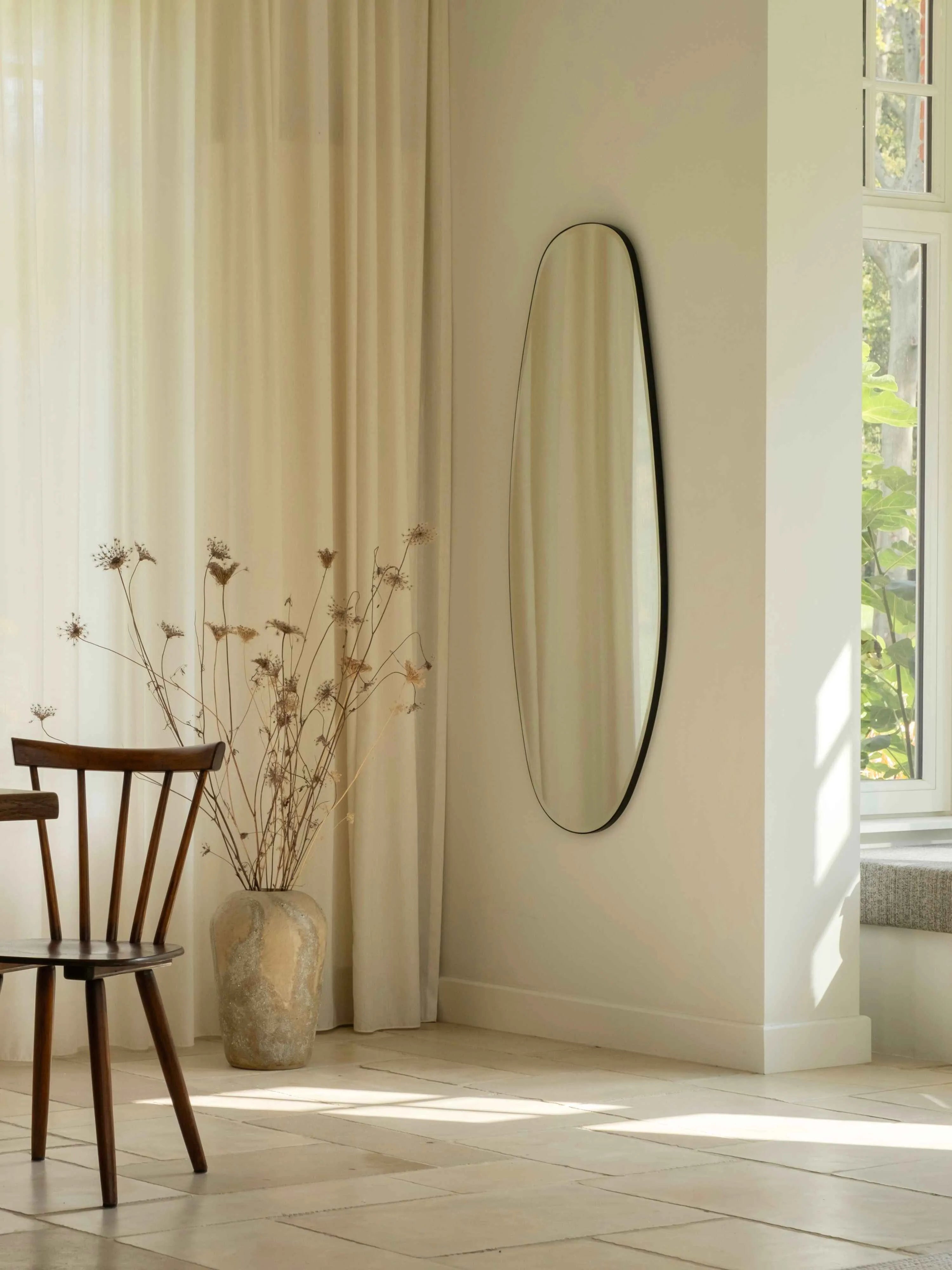 Opal Mirror Large in beautiful living room with natural sunlight in the background