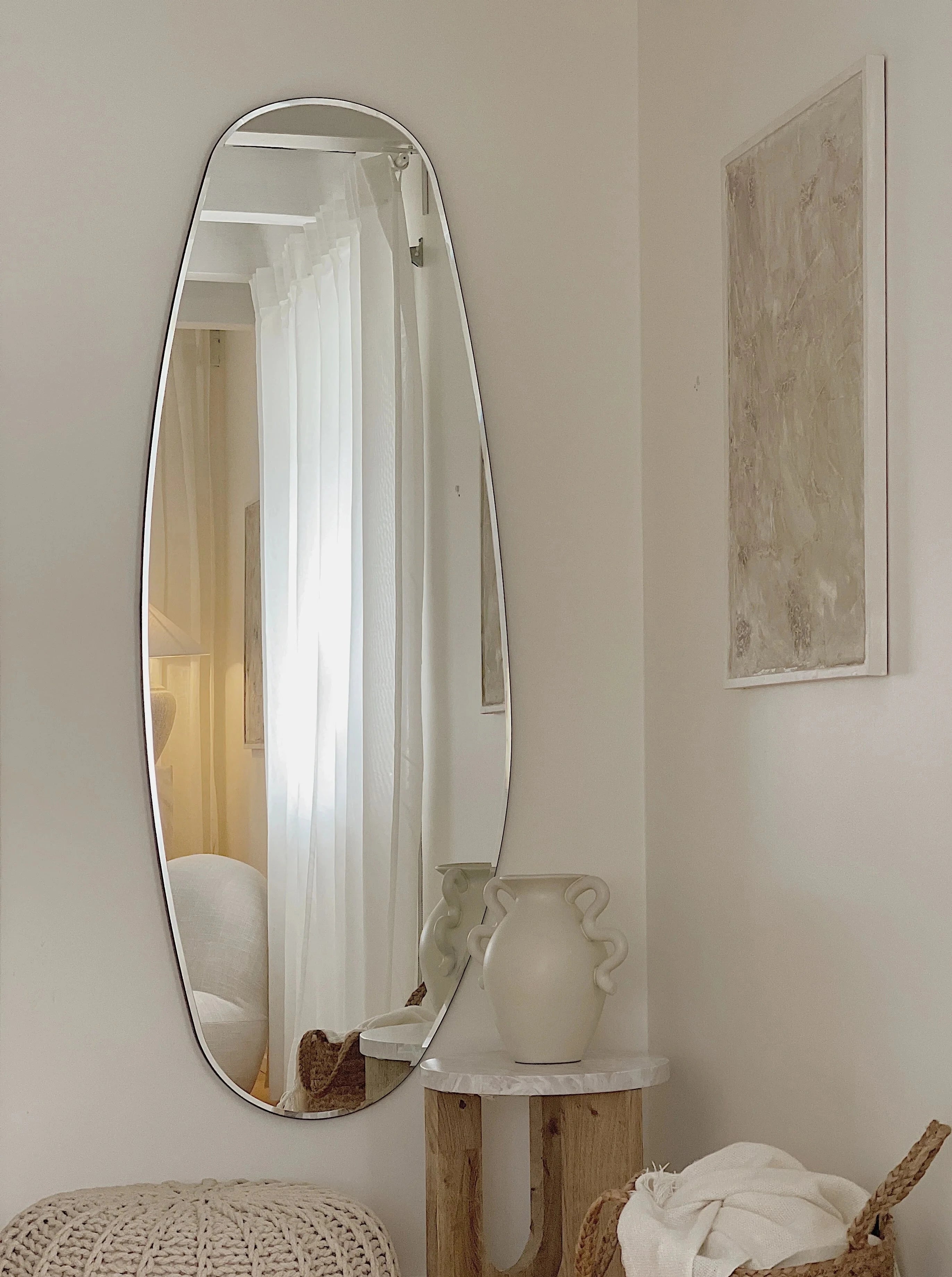 Irregular shaped Opal Mirror on a aesthetic room with vase and picture frame in the background