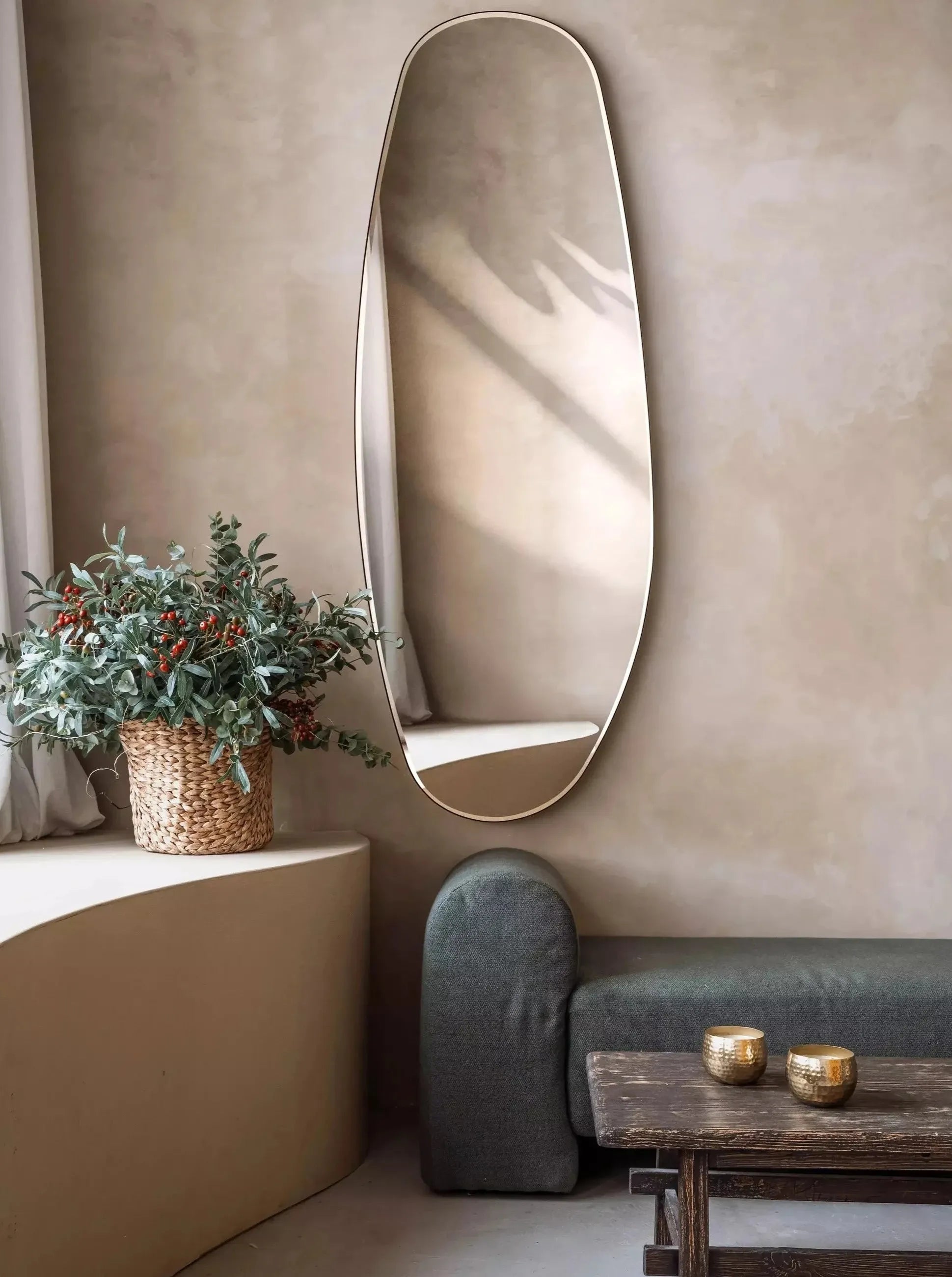 Opal Mirror Large in a beautiful room with plants and a wooden table